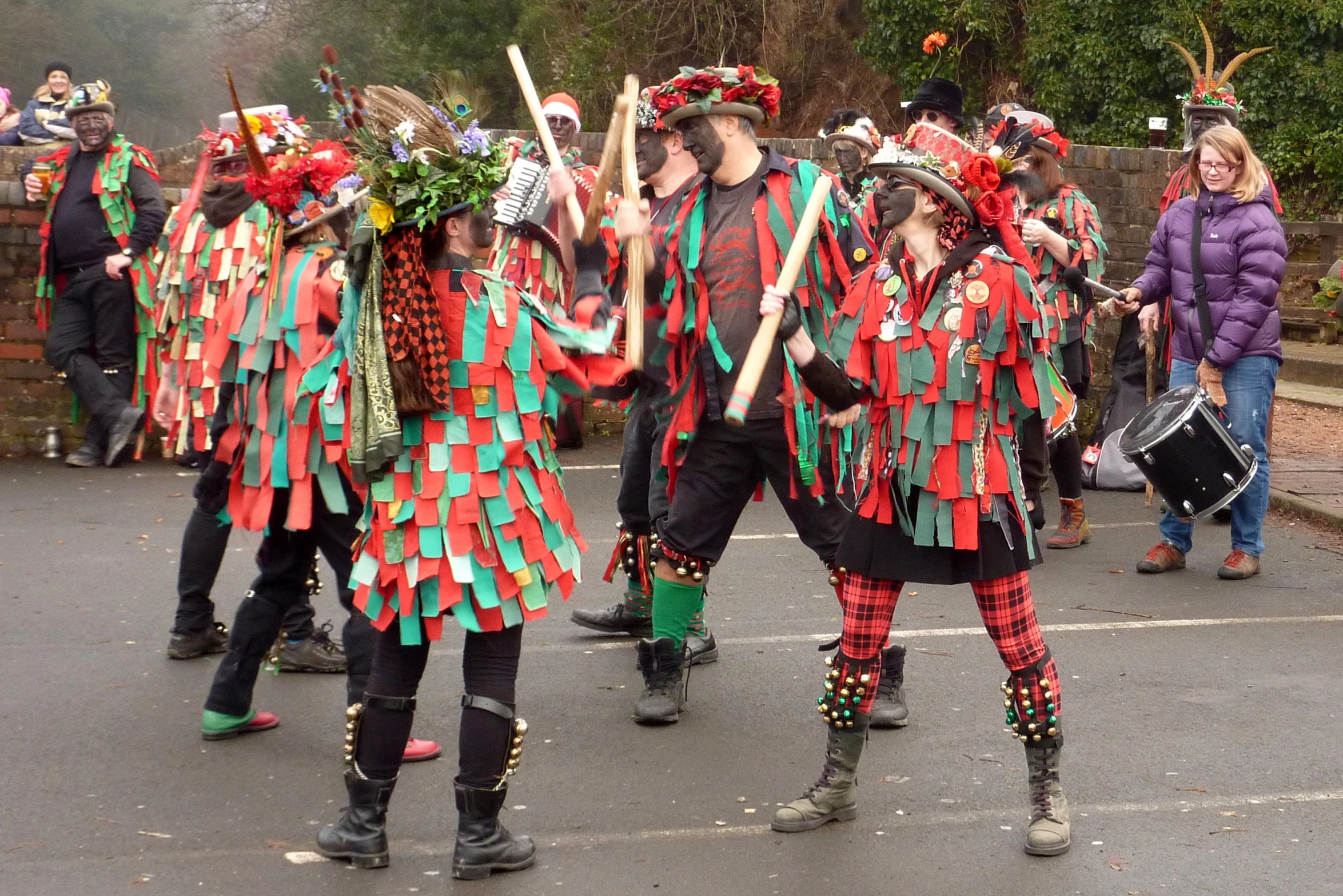 a group of people with costumes performing in the street