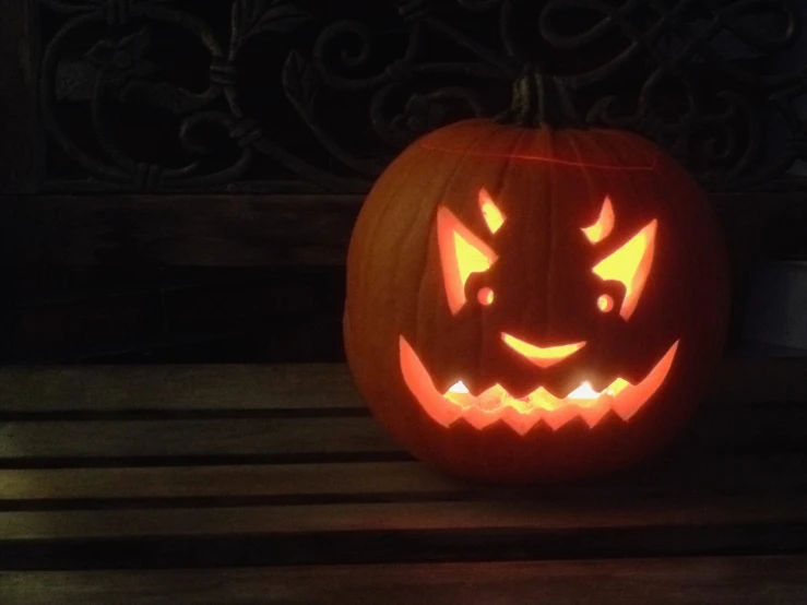 a pumpkin carved to look like an evil face