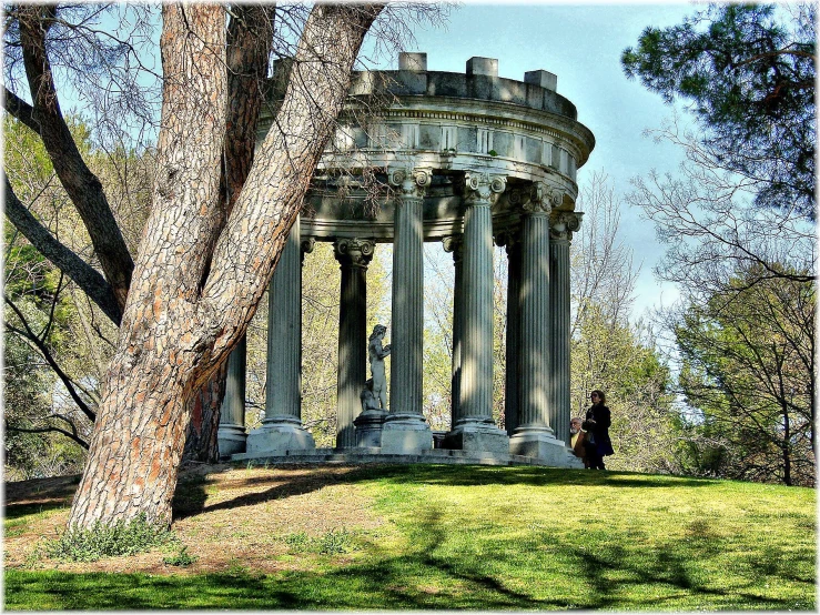 an old stone structure in the middle of a grassy field