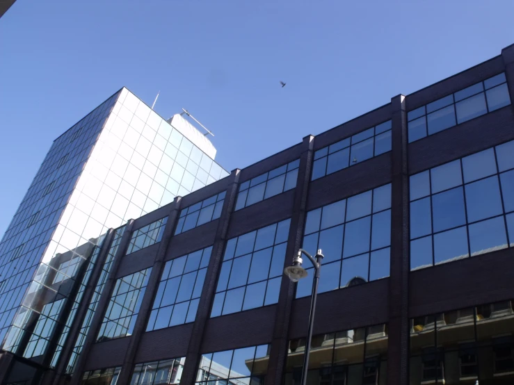 a large building with lots of windows next to a parking meter