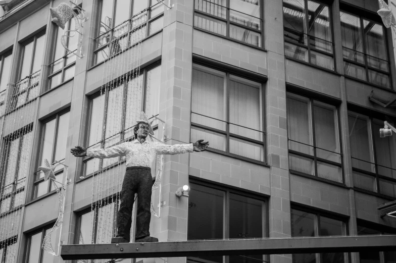 a man with two knives is standing on a ledge