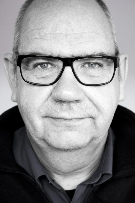 a close up s of a man wearing glasses