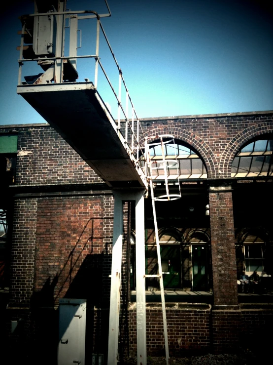 an industrial building with ladder to upper level