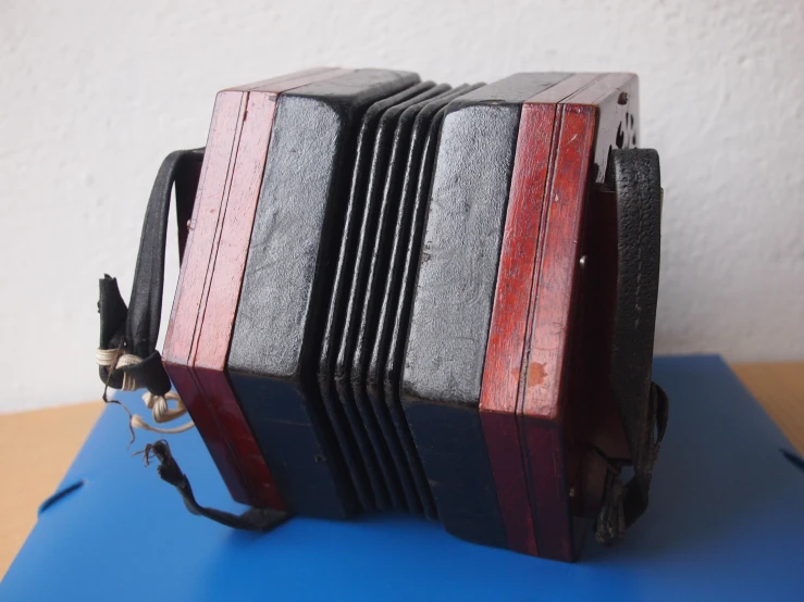 an old accordion is folded and stacked up