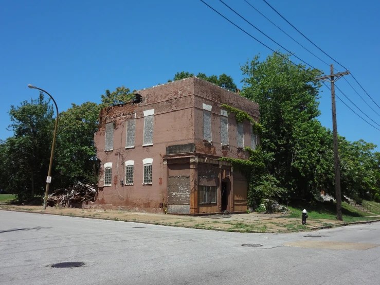 an old brown building on the corner of a street