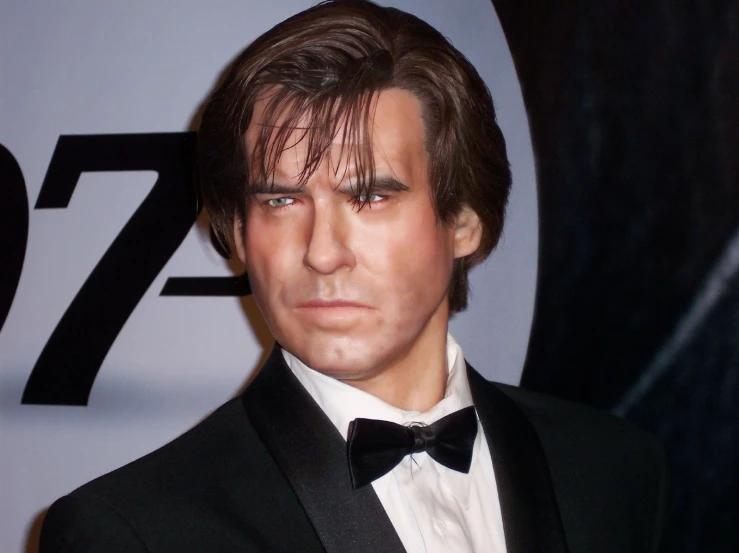 male actor in black suit and bow tie