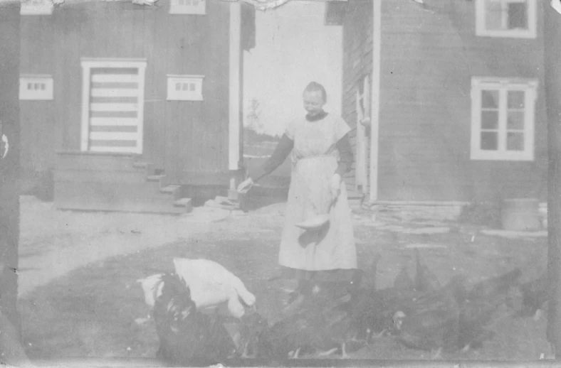 an old po shows two women in front of a house