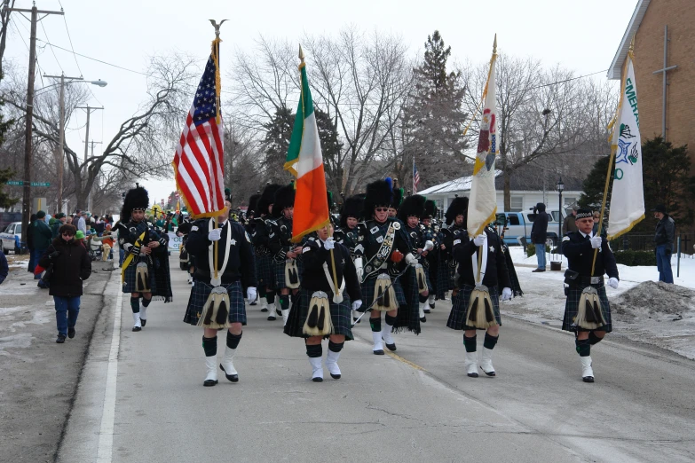 a parade in irish attire leads down a street