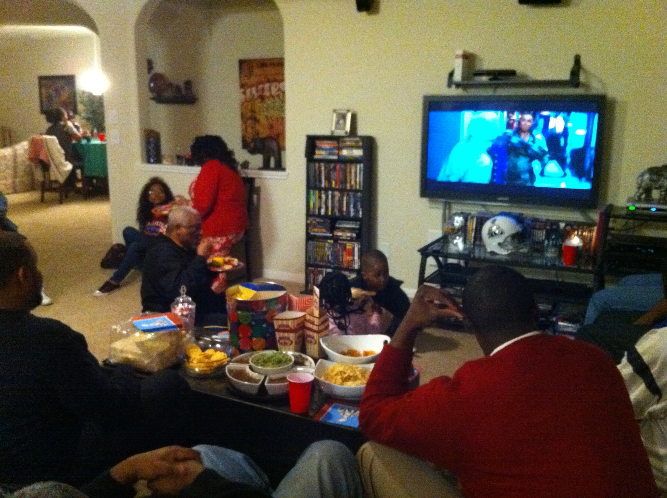 an image of a family watching the tv at christmas time