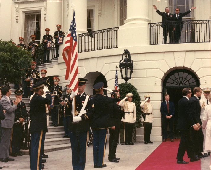 a group of military men standing on top of a red carpet