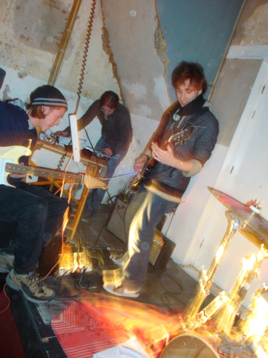 four people are playing music in an unfinished room