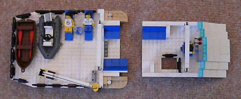 a lego boat with blue paint and other toy boats