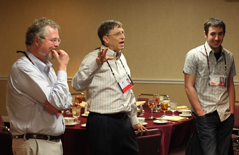 a group of three men standing next to each other