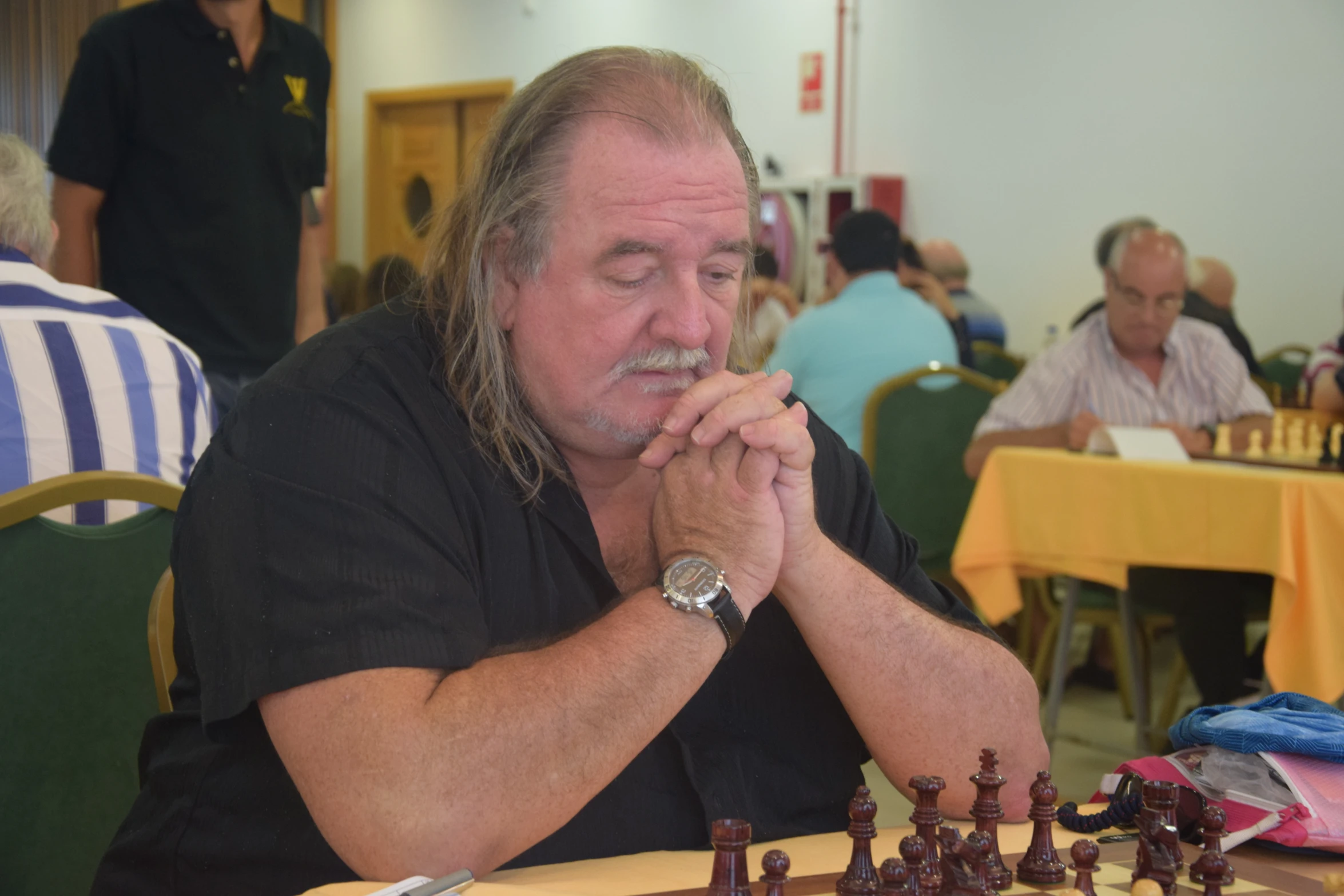 a man with a fake chess game at a table