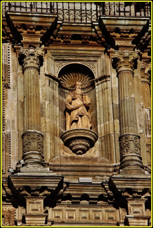 an ornate statue sits outside a building window