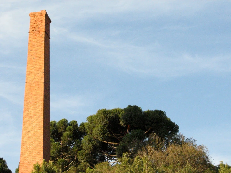 an old tall tower that has trees near by