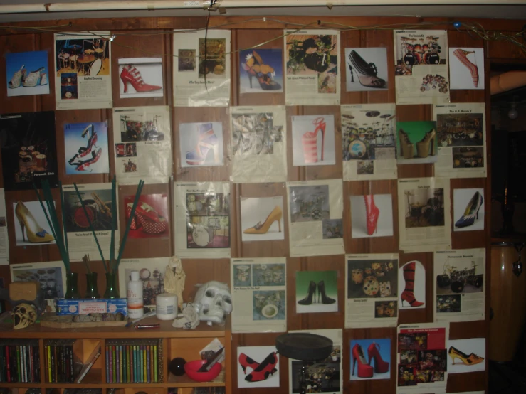 many pictures are posted on the wall above shelves