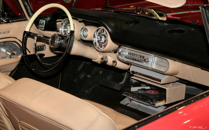 the interior of a classic sports car in tan leather