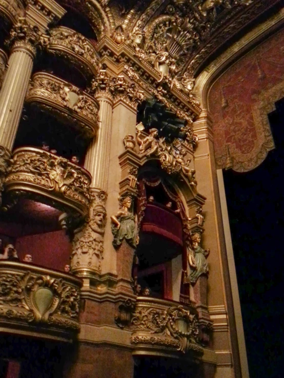 gold painted ornate design at the top of an ornate building