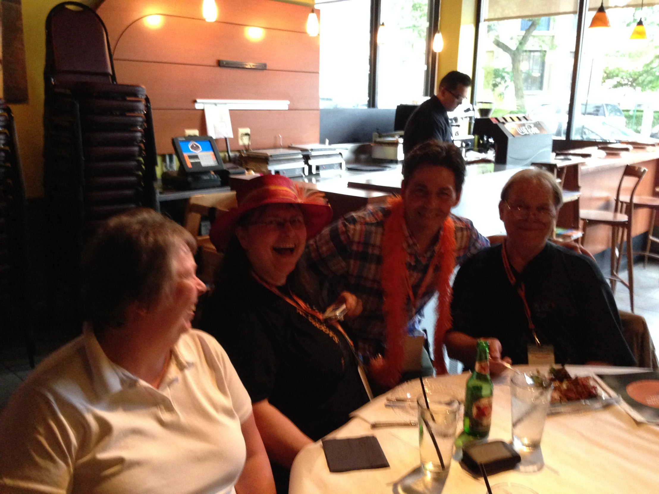 four women sitting down at a table laughing