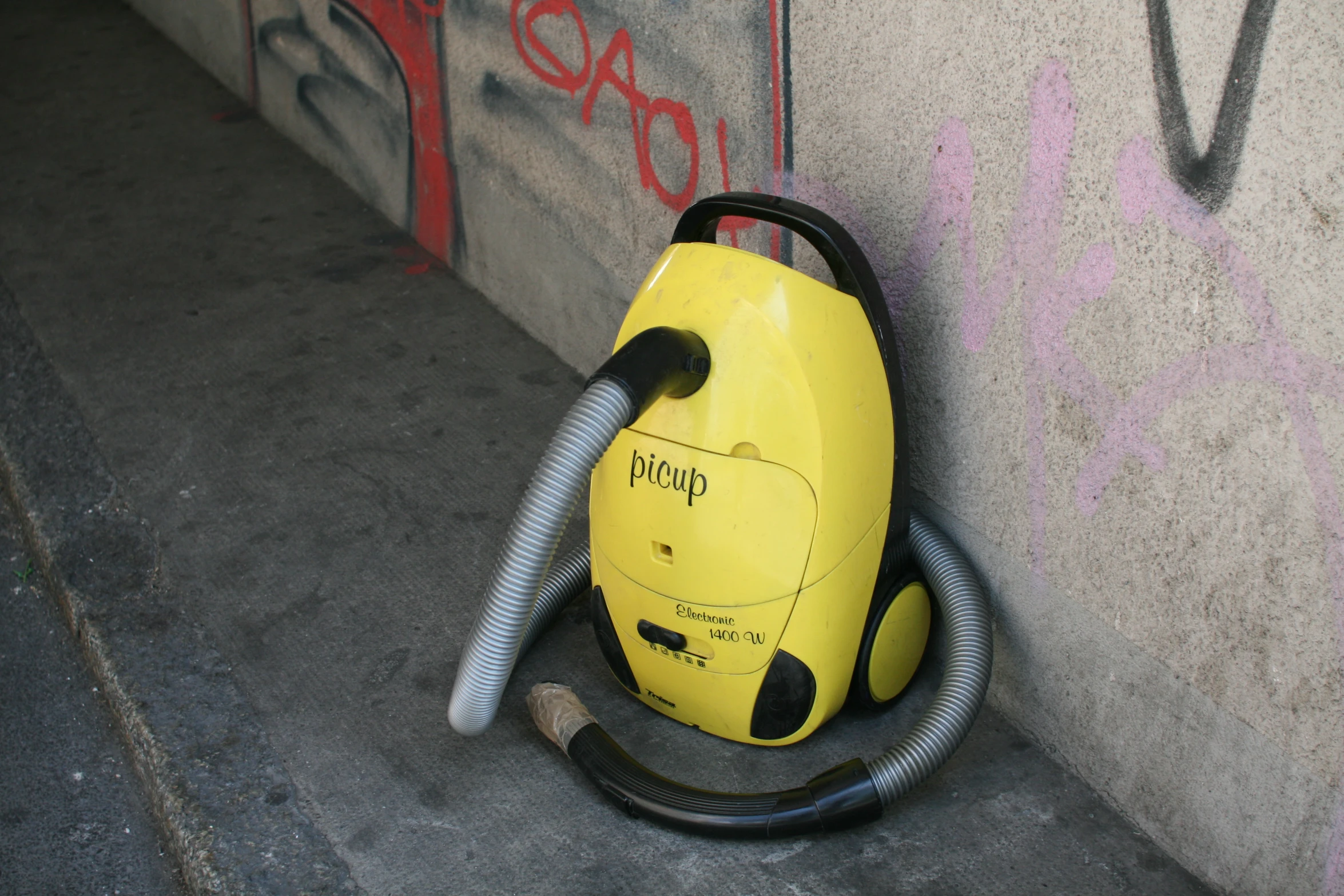 a duster on the ground with graffiti on it