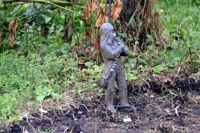 a stuffed toy elephant on top of some grass and dirt