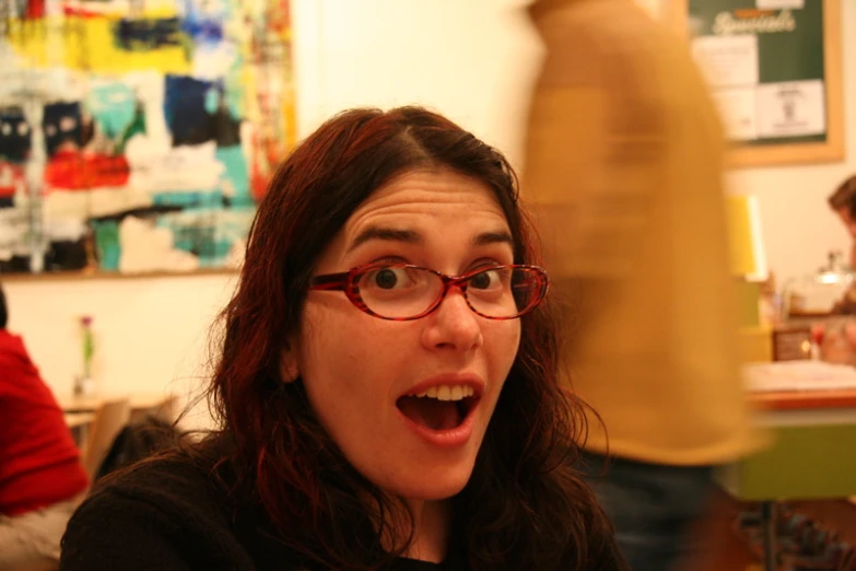 a woman with glasses making a goofy face