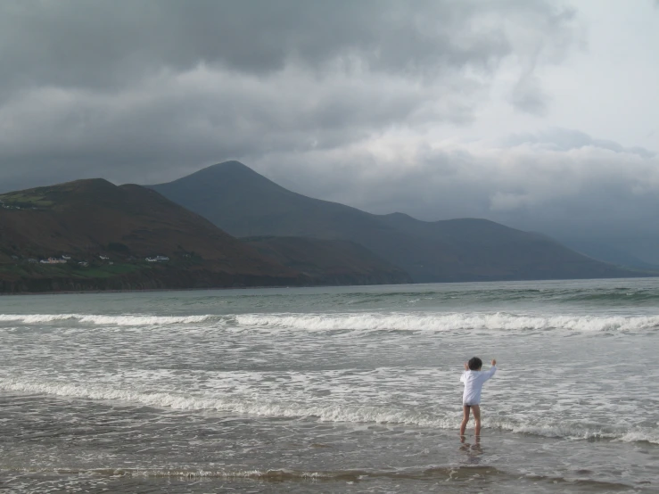 a man is flying his kite on the beach