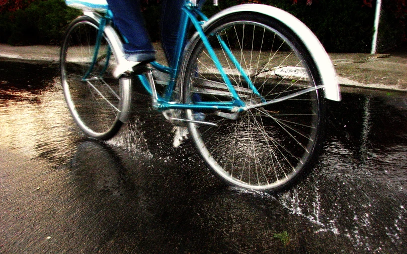 a person riding a bicycle through some water