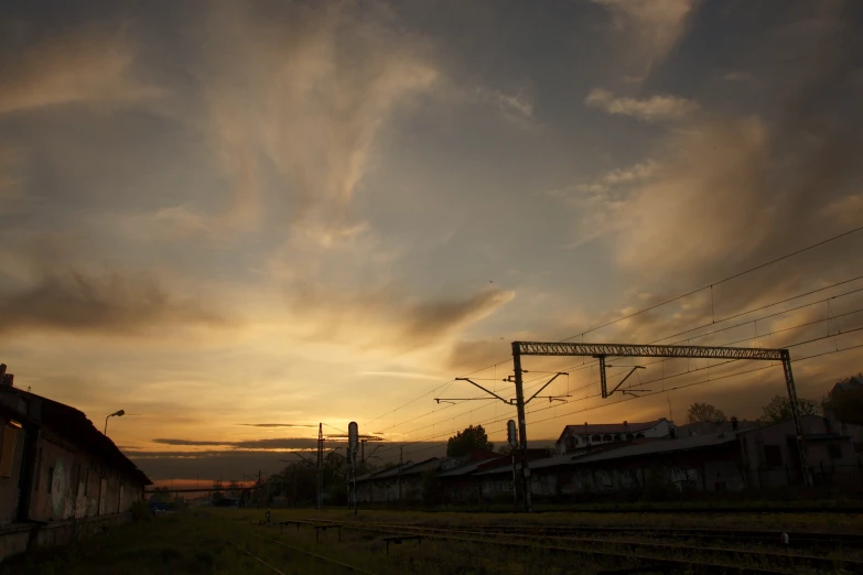 the sky with clouds in it above some train tracks