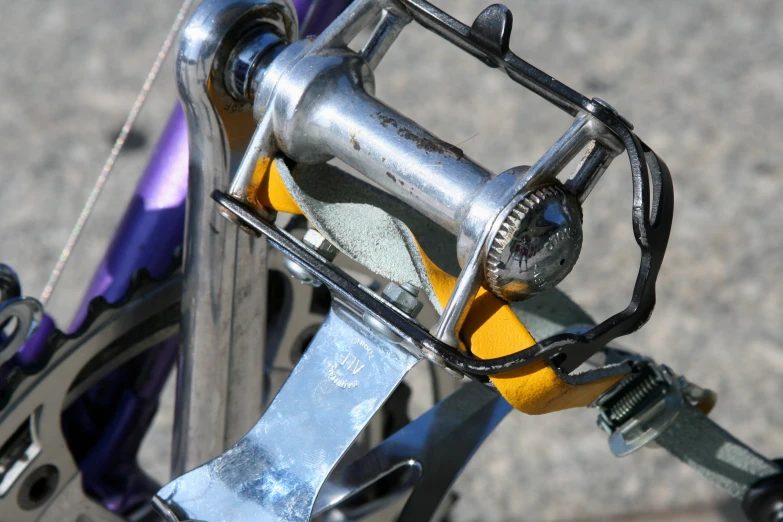 the bicycle is parked next to the street and looks down on the handle