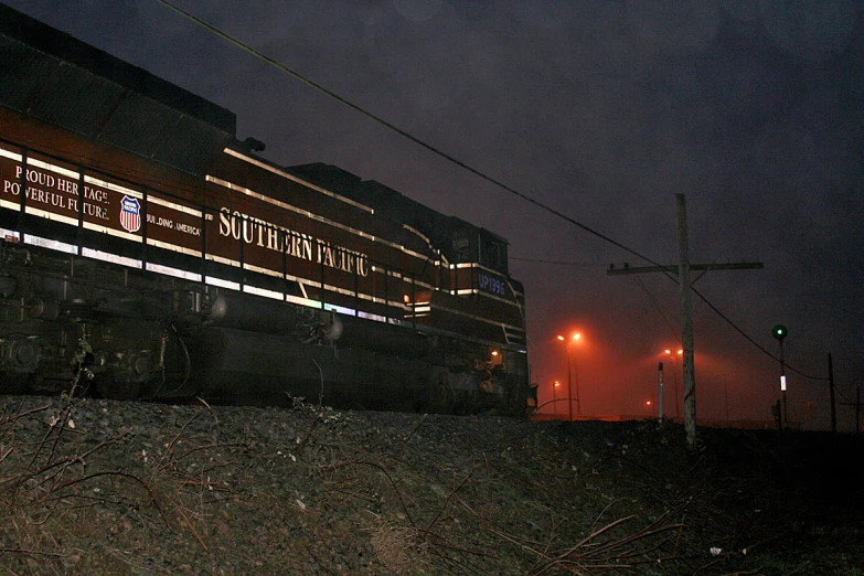 a train that is going on the tracks near some lights