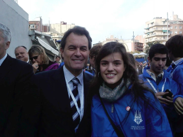 a woman standing next to a man in a suit