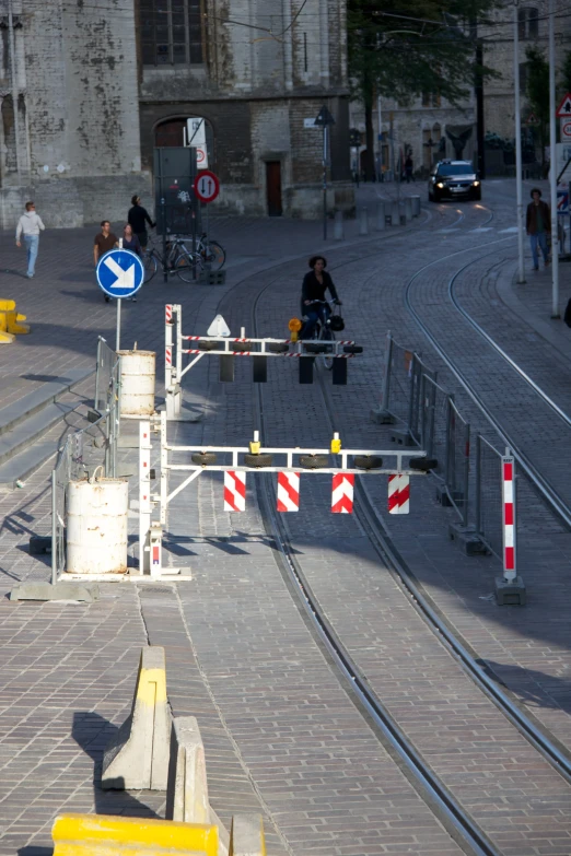 a train track with some people and cars