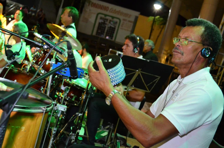 a band plays on stage as a man is listening