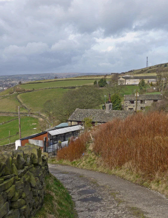 a countryside road runs into a small, stone building