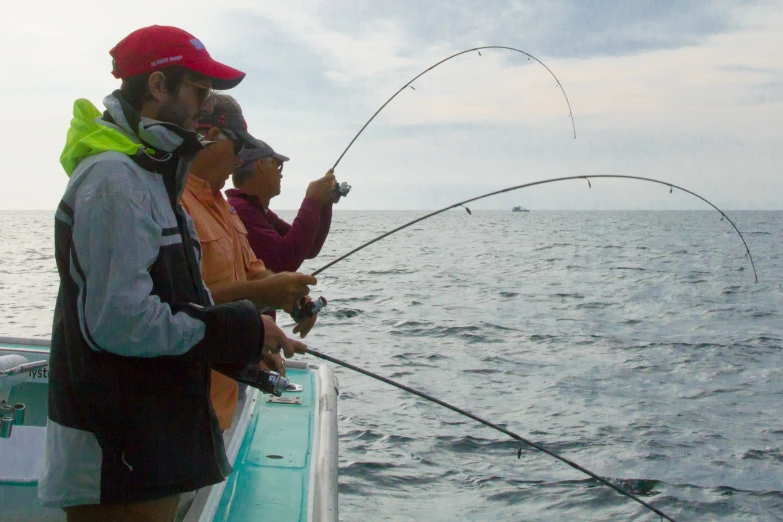 a man and woman are fishing together on the boat