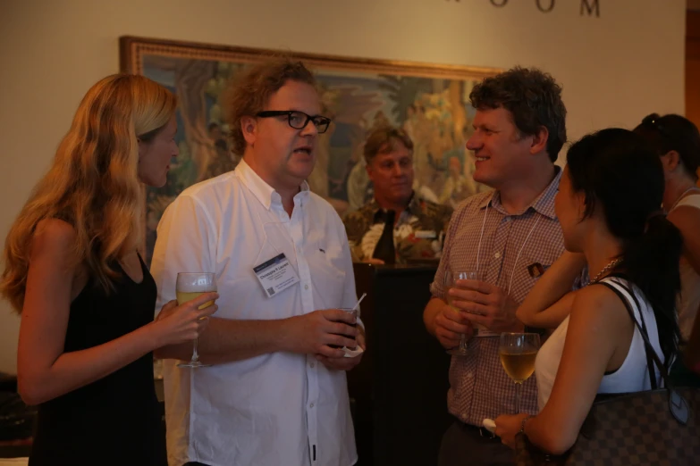 two men and one woman drinking wine while standing together