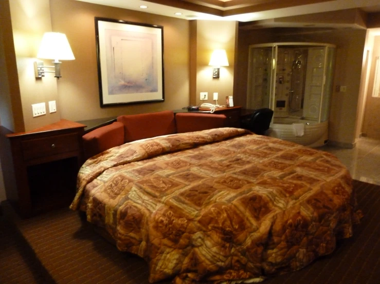 a brown couch and bed sitting in the corner of a room