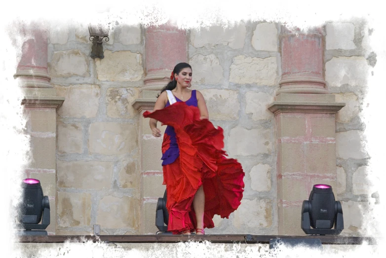 a woman wearing a red and blue dress walking on the street