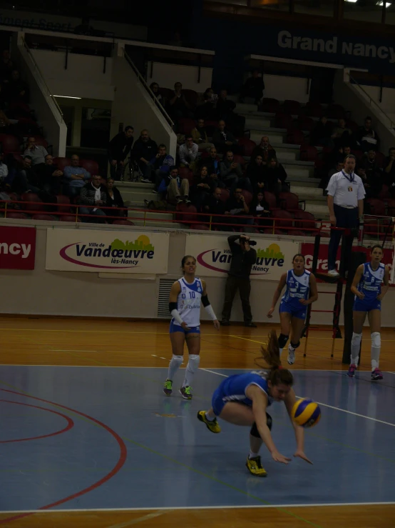 a couple of girls are playing volleyball on a court