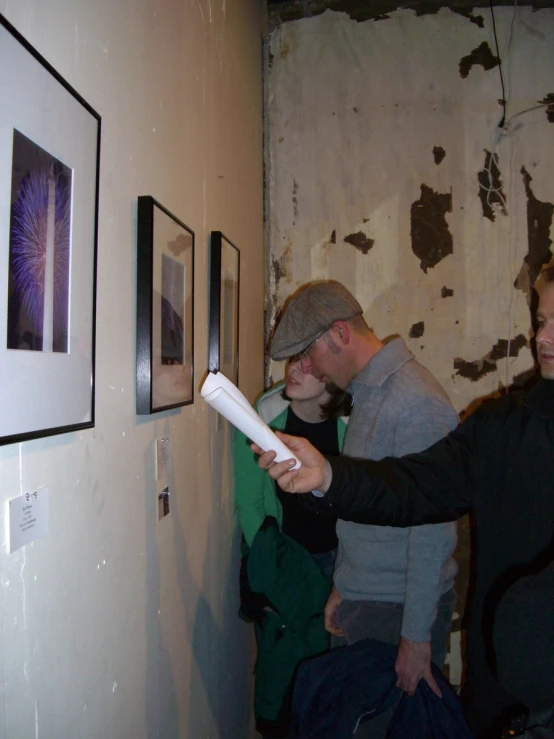 a man is looking at soing as he stands next to a woman