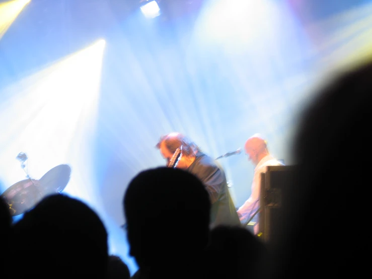 a po taken from the back of a concert showing a man on stage performing