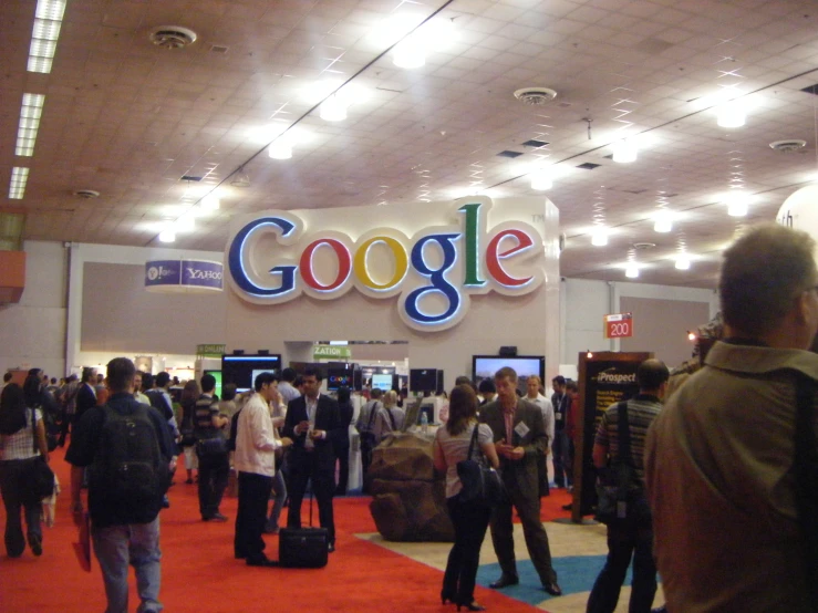 a big crowd of people standing in front of a store