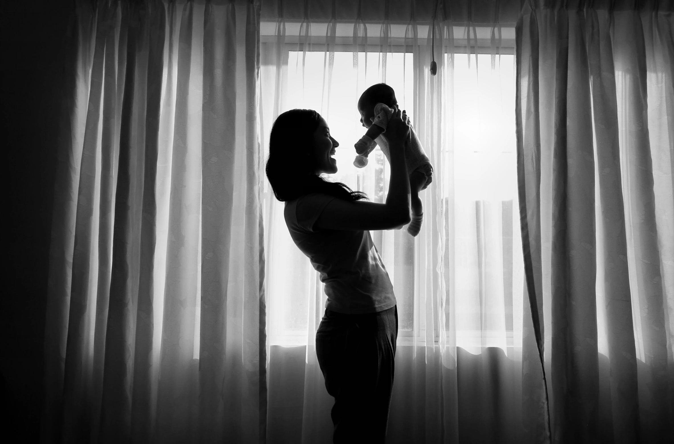 a young child is being held up by his mother