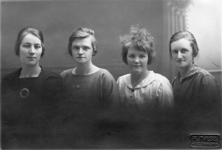 black and white pograph of four women from the same group