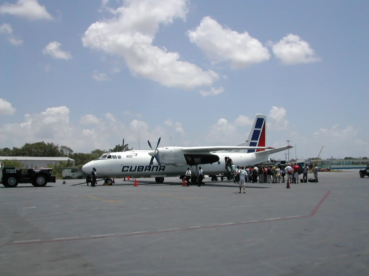 a large group of people gathered around an airplane