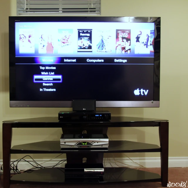 an entertainment center and tv screen displaying movies