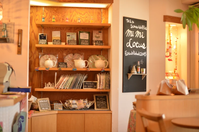 this cafe has wooden shelves full of teas