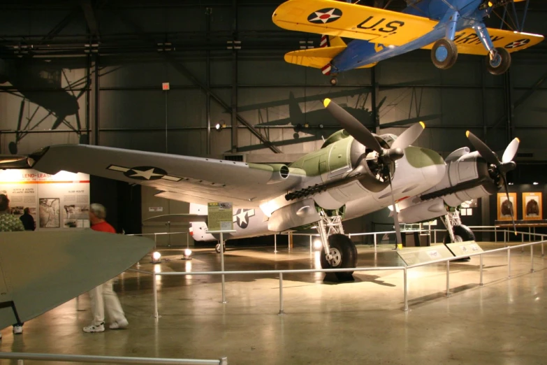 a display case filled with two large fighter planes